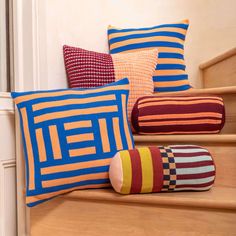 colorful pillows on the steps of a house