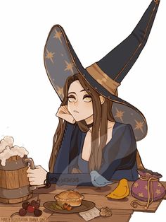 a woman wearing a witches hat sitting at a table with food and drink in front of her