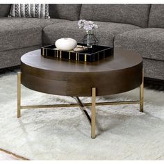 a living room with a couch, coffee table and books on the top of it