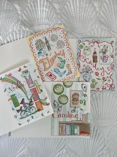 four greeting cards on top of a quilt