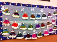 a bulletin board decorated with hats and snowflakes