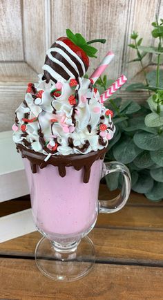 a cup filled with whipped cream and chocolate covered strawberries