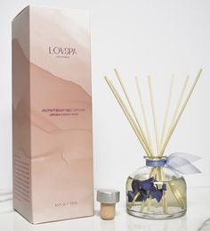 an empty box next to a reed diffuser