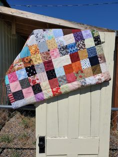 a patchwork quilt on top of an old door