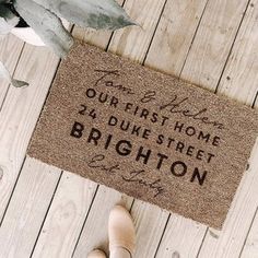 someone is standing in front of the door mat that says, our first home was built on