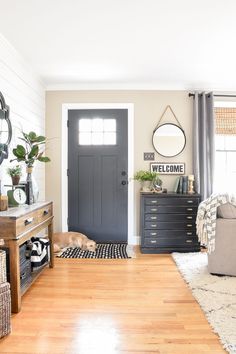 a living room filled with furniture and a black door