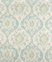 an upholstered fabric with green and white designs on the front, in shades of blue