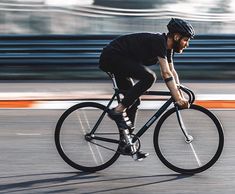 a man riding a bike down a street