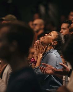 a group of people sitting and praying together