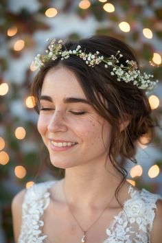 a woman wearing a flower crown smiles at the camera