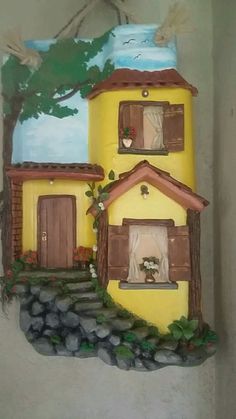 a yellow house painted on the side of a wall