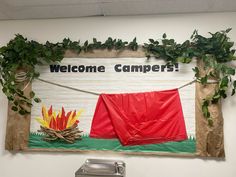 a welcome camper sign hangs on the wall next to a fire extinguisher