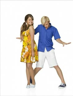 a man and woman are posing for a photo together in front of a white background