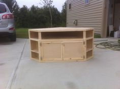 a wooden entertainment center sitting on top of a driveway