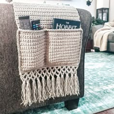 a crocheted book holder on a couch in a living room