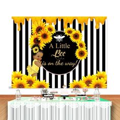 a baby is on the way banner with sunflowers and bees in black and white stripes