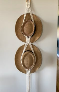 two hats are hanging on the wall