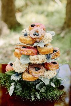 donuts stacked on top of each other with sprinkles and blueberries