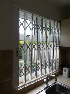 a kitchen with a sink and window in it