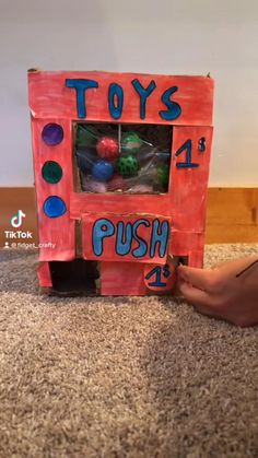 a toy truck made to look like a push button machine with lots of balls in it