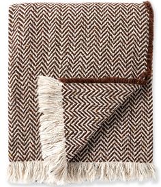 a brown and white blanket with fringes