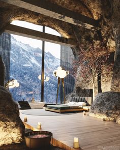 a living room filled with furniture next to a large window covered in snow capped mountains