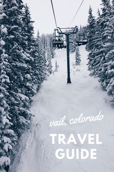 a ski lift going up the side of a snow covered mountain with trees on both sides