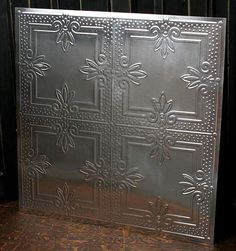 a metal panel with decorative designs on it