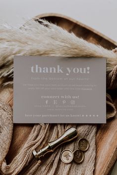 a thank card sitting on top of a wooden tray