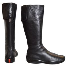 Vintage Prada Knee High Black Leather 2000s Tecnical boots ! MADE IN ITALY. 15” tall Smooth Black leather Outer Fully lined interior Rubber Soles Full zip up back with Velcro detail U.K. Size 4.5 / EU Size 37 Heel height : 2cm Condition : 7/10 Great Overall condition despite general minor wear - no notable flaws to mention. Pink Balenciaga, Pirate Boots, Prada Vintage, Manolo Blahnik Black, Orange Heels, Vintage Prada, Balenciaga Logo, Valentino Black, Black Houndstooth