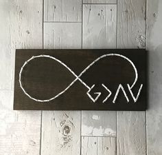 a wooden sign with the word love and an infinite knot on it's side