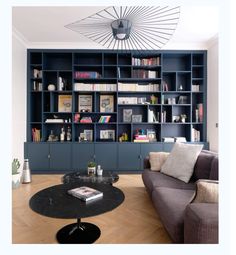 a living room filled with furniture and bookshelves