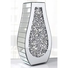 a white vase filled with lots of silver glitter