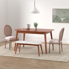 a dining room table with two chairs and a bench in front of it on a rug