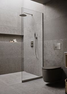 a bathroom with a glass shower door and toilet