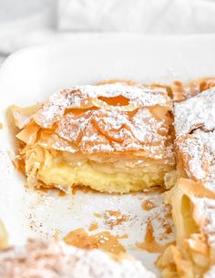 some food is on a white plate with powdered sugar