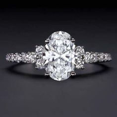 an oval cut diamond ring with diamonds around it