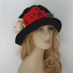 I love making unique hats. Everytime I make this hat feel like creating a painting. Not just a hat it's an art. This hat is black with red and cream flowers and green leaves. Please make sure choose the correct size if you want it fit perfect. If you are interested in an item but would prefer a different size or color feel free to contact us and we'll try to make it for you. I can make the flowers almost any colors in my store upon request. Always smoke, pet free home. Unique Handmade Brimmed Mini Hats, Black Hand Knitted Bohemian Hats, Black Hand-knitted Bohemian Hats, Unique Brimmed Winter Hat, Black Handmade Vintage Fedora, Unique Winter Brimmed Hat, Handmade Vintage Cloche Hat, Black Artistic Hat With Short Brim, Artistic Black Hat With Short Brim