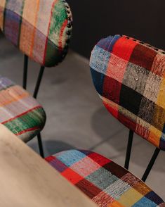 two multicolored chairs sitting next to each other