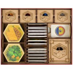 an open box with several different items in it, including plates and spoons on the inside