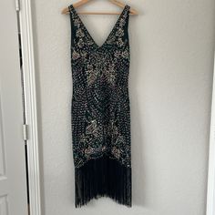 Nwt Babeyond Green V-Neck Dress Size: M Color: Deep Iridescent Green And Black Back Of Neck To End Of Fringe: 30 In (See Pic) Pit To Pit: 18 In Sleeveless, Sequined With A V-Neck Front And Deep V Back. Never Been Worn. Gorgeous Flapper Style Dress With Fringe. Beading Is Very Detailed With A Mix Of Sequins, Beads And Thread Also Included: Feather Headpiece Great For Halloween, Cosplay, Roaring 20’s Party Etc Embellished Flapper Dress For Costume Party, V-neck Party Dress With Beaded Fringe, Black Embellished Dress For Costume Party, V-neck Party Dresses With Rhinestone Fringe, Glamorous V-neck Dress With Rhinestone Fringe, Embellished Sequin Dress For Costume Party And Holiday, Embellished Dress For Costume Party During Party Season, Holiday Embellished Midi Dress For Evening, Glamorous V-neck Flapper Dress For Party Season