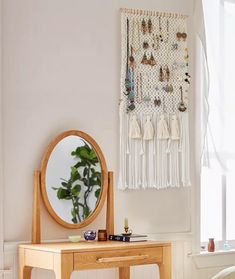 a small wooden table with a mirror on it