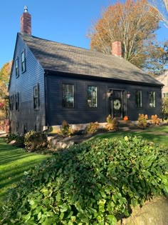 a black house is shown in the fall