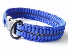 a close up of a blue rope bracelet with a metal hook on it's end