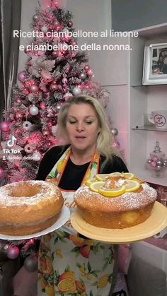 a woman holding two large cakes on top of plates