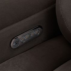 closeup of the center console buttons on a black leather car seat with chrome trim