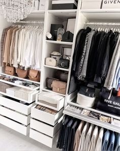 an organized closet with clothes and handbags on the shelves, chandelier hanging from the ceiling