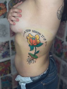 a woman with a flower tattoo on her stomach and the words, stop digging up