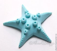 a starfish made out of plastic beads on a white surface