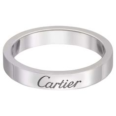 a white gold ring with the word carrier engraved on it